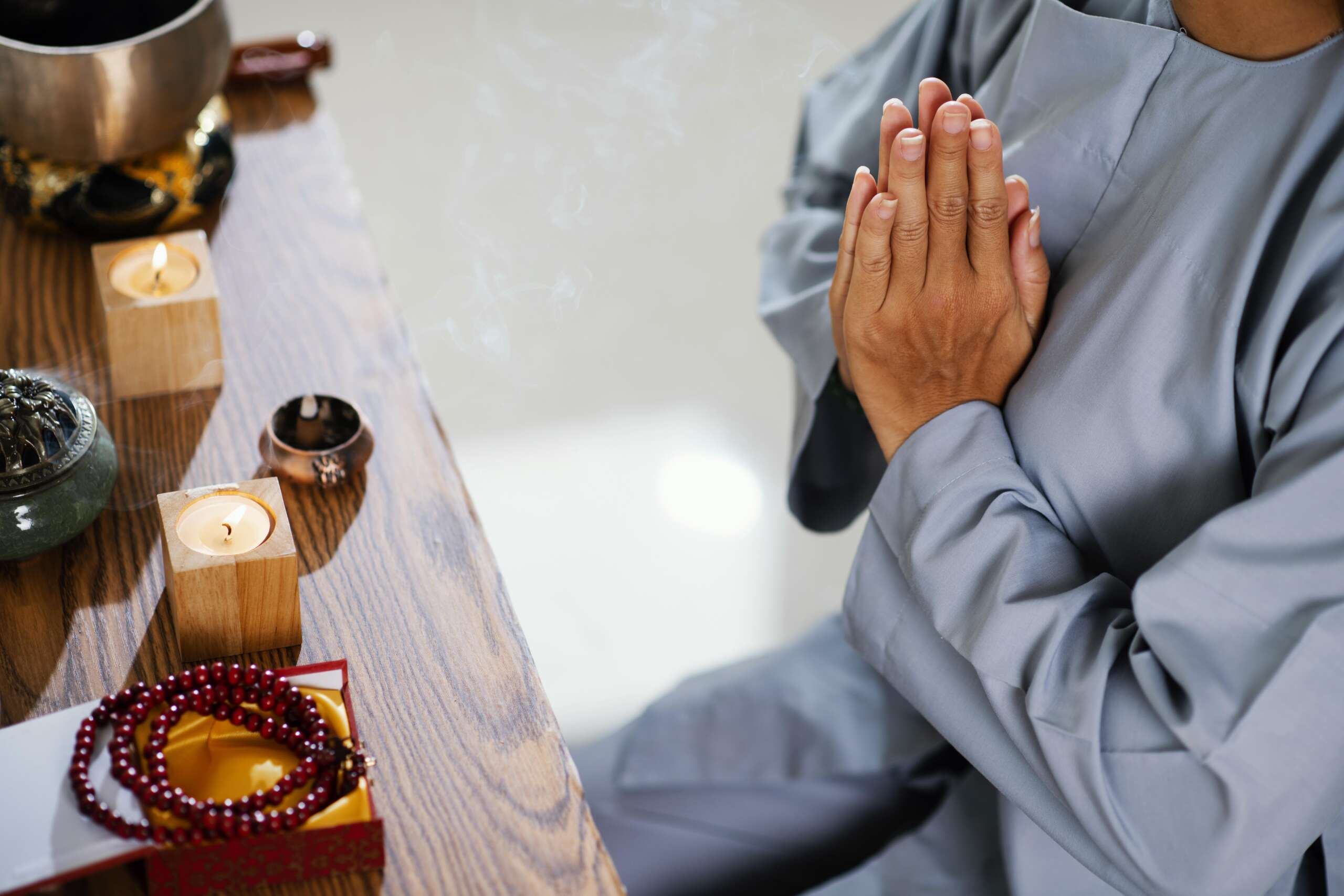 high-angle-woman-praying-front-candles