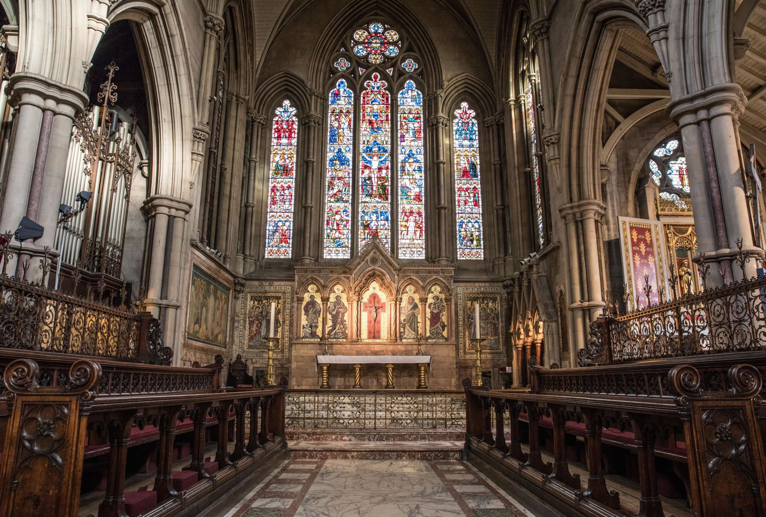 A beautiful shot of the inside view of a church with religious icons on the walls and windows