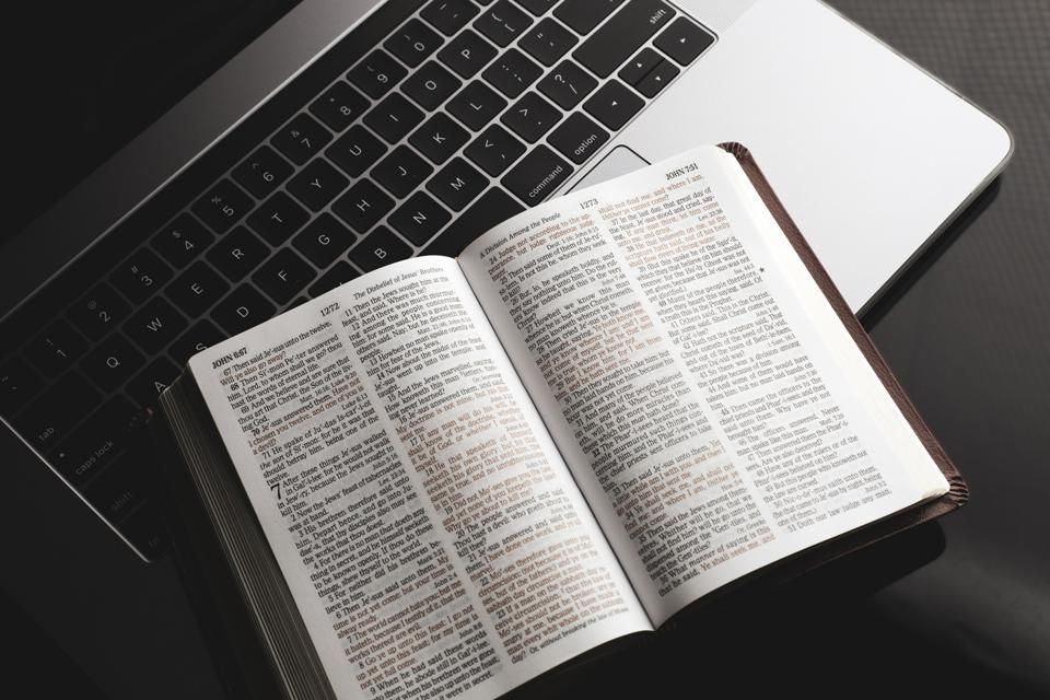 Bible on top of a laptop
